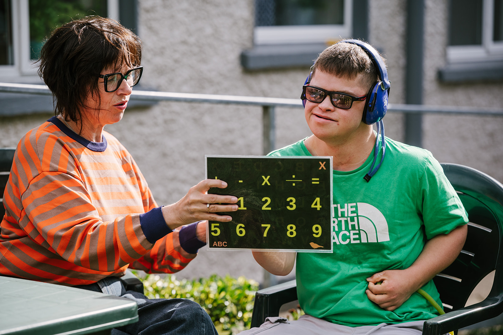 Adult speller communicating using a board with support from a communication partner.