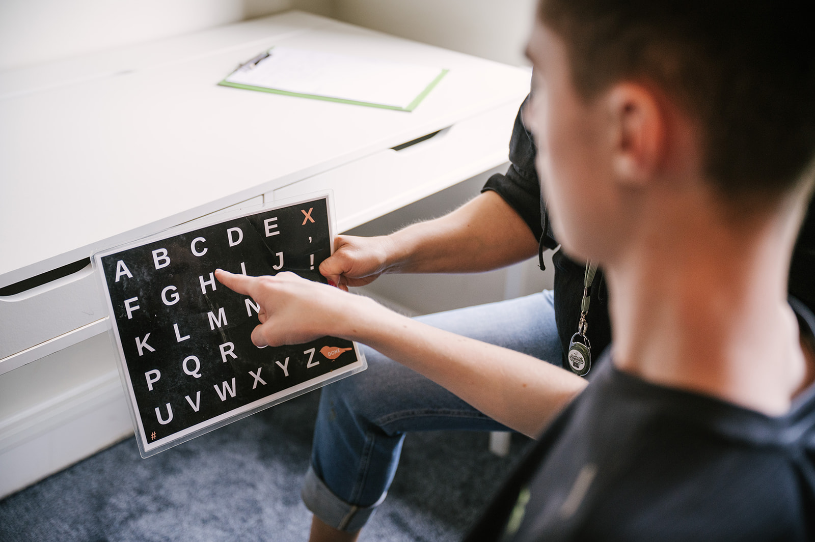 Young speller communicating on a letterboard during a Spelling Alliance of Ireland session.