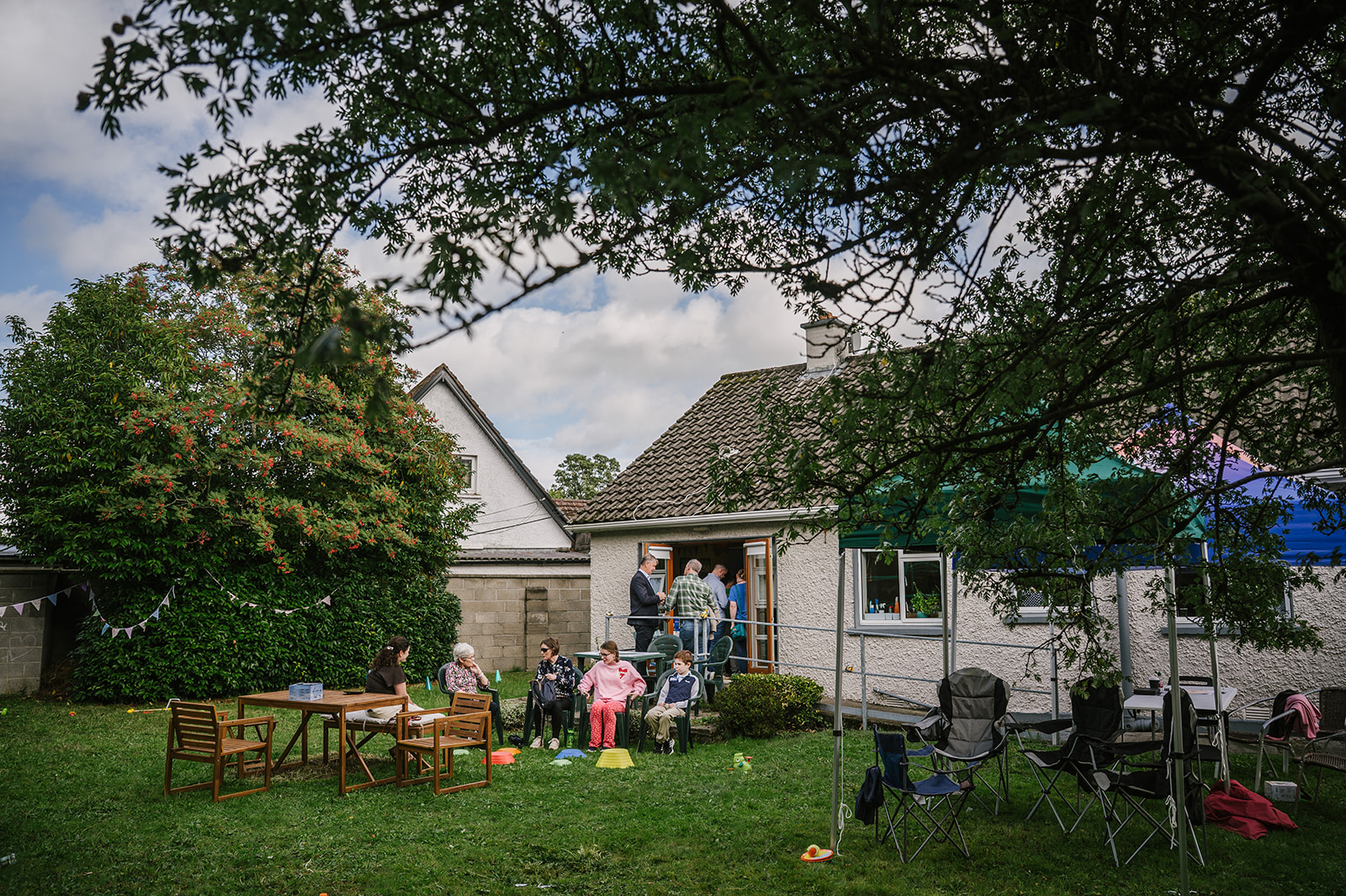 People gathered together outdoors in conversation during a Spelling Alliance of Ireland event.