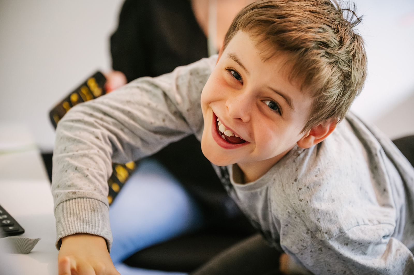 Smiling young speller leaning forward during a Spelling Alliance of Ireland gathering.